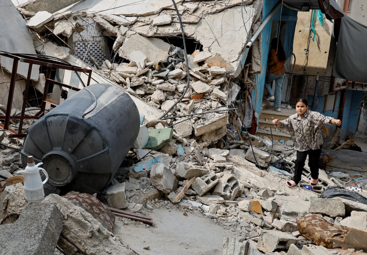 A person tries to walk among debris following a several day long Israeli-raid, in Jenin, in the Israeli-occupied West Bank, September 6, 2024. REUTERS/Raneen Sawafta  