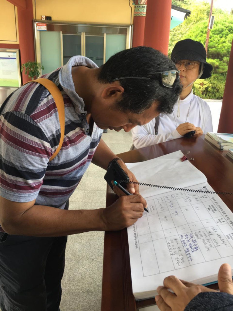 Paying homage to fellow democrats and rights activists, signing the visitor’s book, May 18th National Cemetery, Gwangju, South Korea.