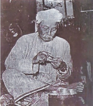 Thakhin Kodaw Hmaing, at home in Rangoon, making betel nut for chewing. Wikipedia Commons